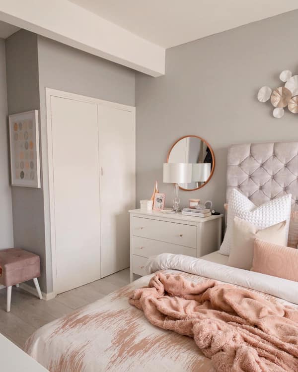 Rose Gold Bedroom Vanity Mirror Round Mirror Behind the Lamp on the Bedside Dresser