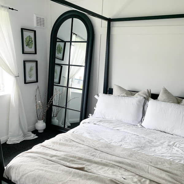 Black and White Bedroom with Large Window Mirror