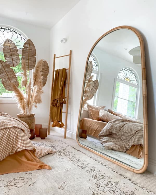 Boho Bedroom with Big Mirror Leaning Against the Wall